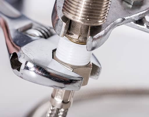 wrench tightening a plumbing fiture